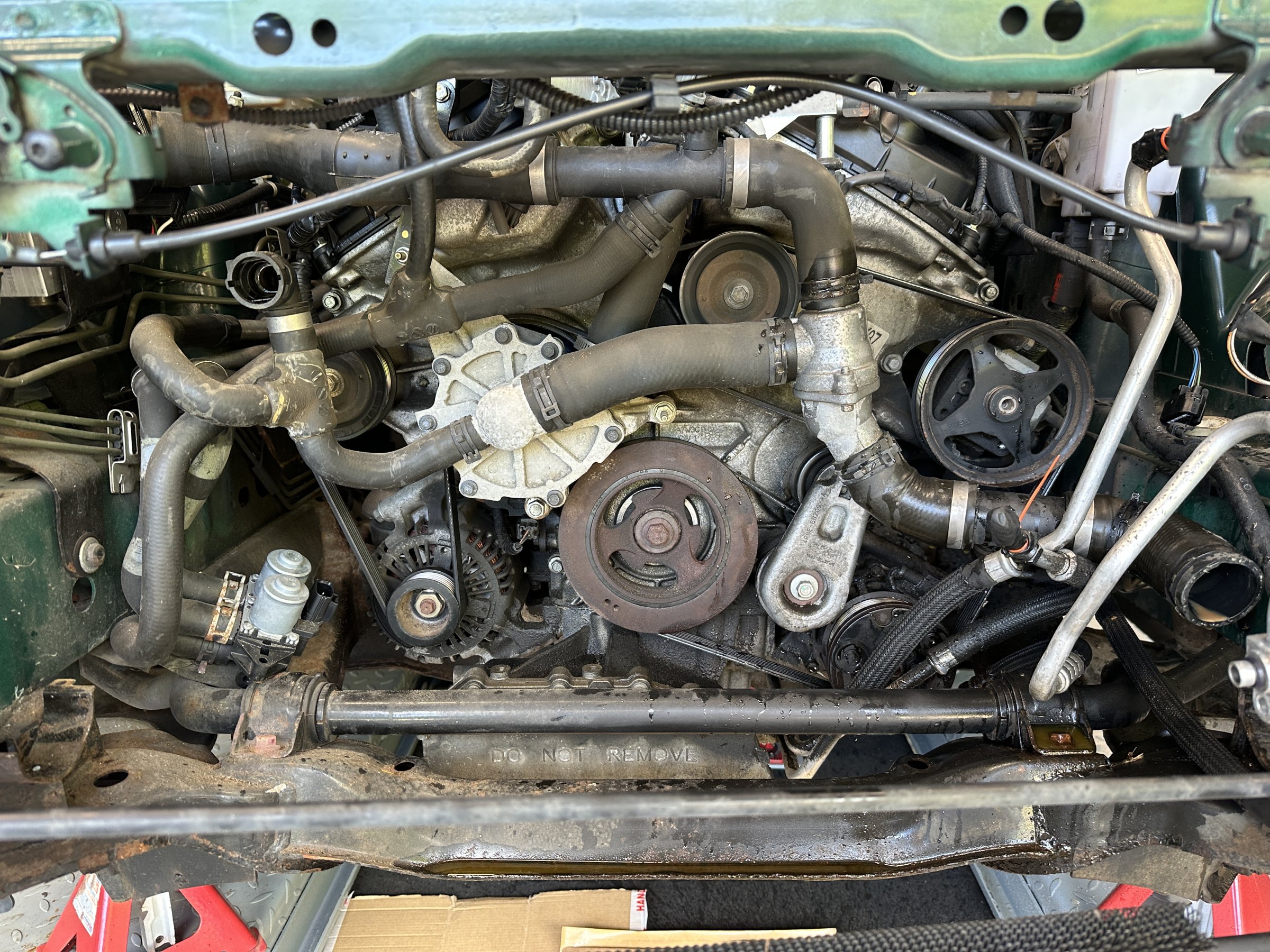 Ready to remove hoses, thermostat housing, water pump, idlers and Aux Drive Belt